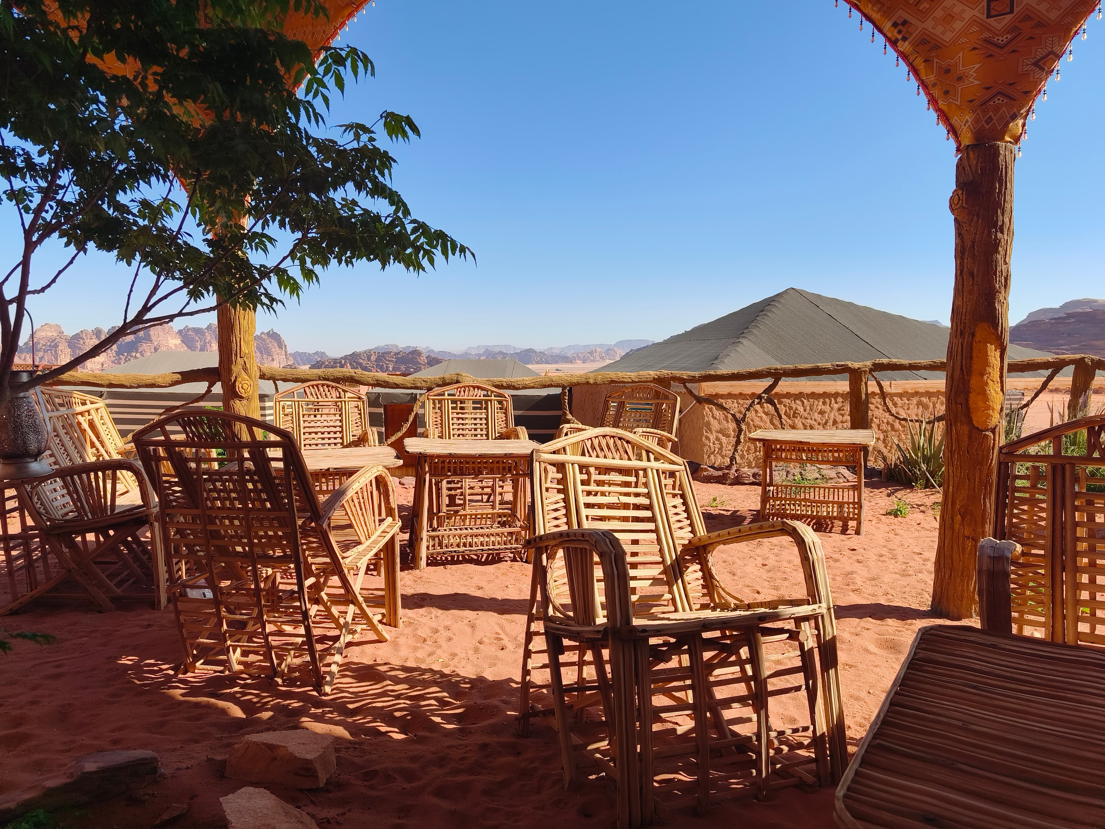 Desert Magic Camp nestled at the foot of sweeping red sandstone mountains