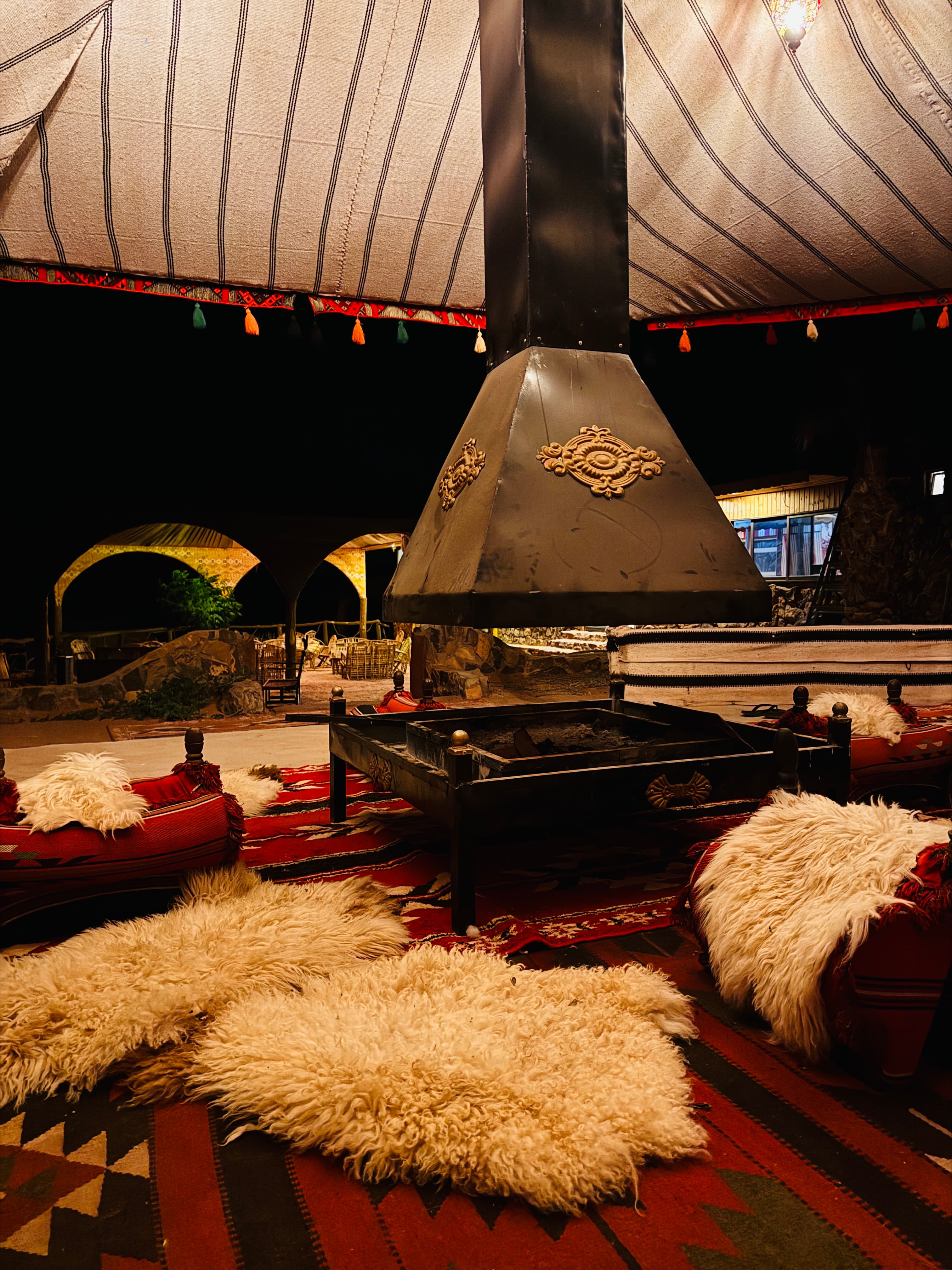 The camp fire lounge warmly lit at night
